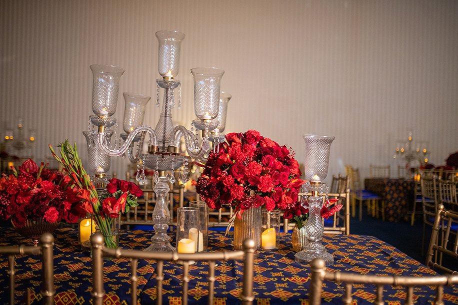 Red floral centrepieces and elegant dinner styling
